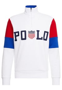 Bílá mikina na zip s červenými a modrými rukávy. Na přední straně logo "POLO" s motivem štítu obsahujícího hvězdy a pruhy.