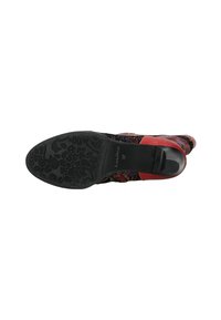 Zapato multicolor con un upper de textil estampado, detalles en rojo y una suela de goma negra texturizada con diseños florales. Talla 37.