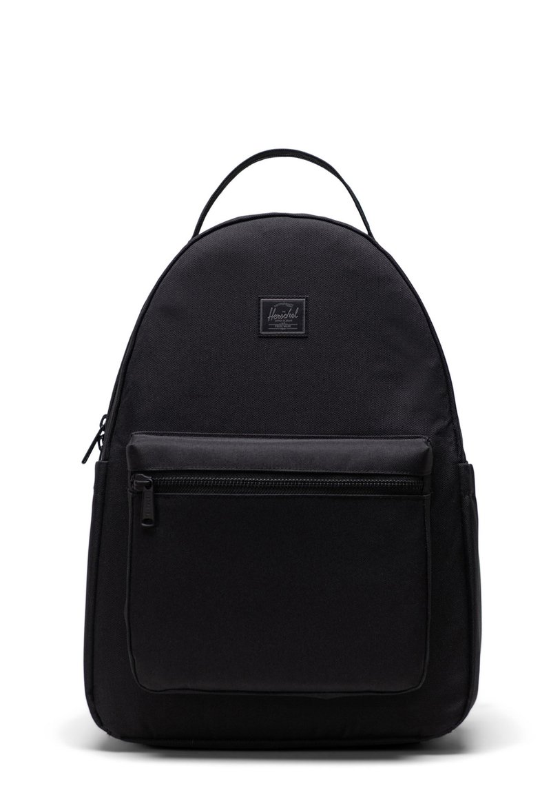 Black backpack made of durable fabric with a rounded shape, front zipper pocket, top handle, and signature brand patch.