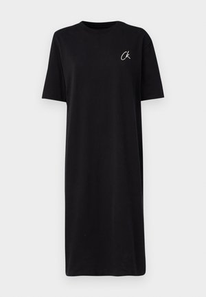 Black T-shirt dress made of cotton, featuring a round neckline and short sleeves. Small white "CK" logo on the left chest.