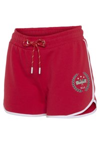 Red jersey shorts with a white trim, elastic waistband, and drawstring. Features an embroidered logo and emblem on the front.