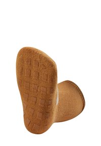 Brown ankle sock with a textured, rubber grip sole featuring square patterns; made from a knitted material with a soft finish.