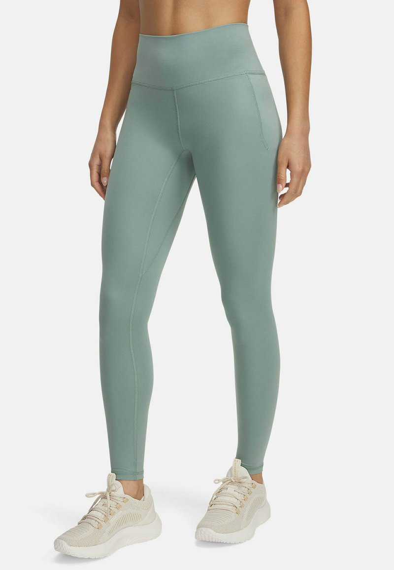 High-waisted, mint green leggings made of stretchy fabric with flat seams. Features a side pocket and form-fitting design.