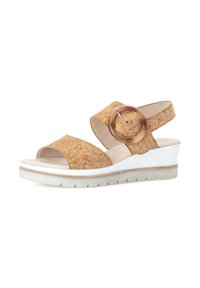 Cork wedge sandals with open toe, brown cork upper, white sole, and a clear round accent on the strap. Textured surface and light cushioning.