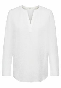 Blouse blanche texturée à manches longues avec col en V et ourlet arrondi, conçue pour une coupe décontractée.
