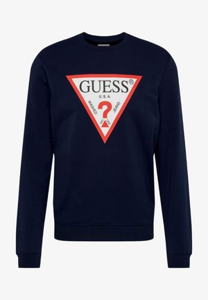 Sudadera azul marino de cuello redondo que presenta un gráfico triangular en rojo y blanco con "GUESS U.S.A." y un logo de signo de interrogación en el centro.