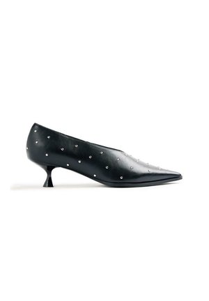 Zapato negro de cuero con puntera puntiaguda y tacón bajo tipo kitten, con pequeñas tachuelas plateadas distribuidas de manera uniforme en la superficie.