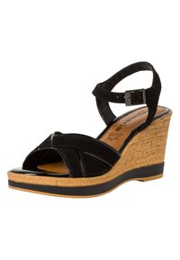 Sandalias de cuña negras con parte superior de ante, punta abierta, correa en el tobillo y textura de corcho en la cuña. Presenta un acento brillante de charol negro.