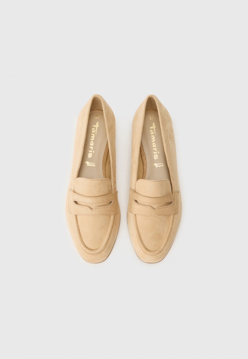 Beige Wildleder-Loafer mit flacher Sohle, abgerundetem Zehenbereich und dekorativem Riemen mit Ausschnitten. Goldene Markierung auf der Innensohle.