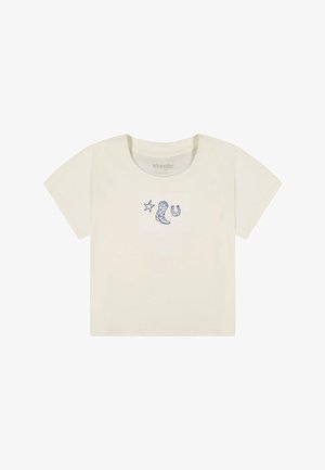 Crop top crème à manches courtes avec des dessins en ligne bleu marine d'une étoile, d'une botte de cowboy et d'un fer à cheval centrés sur la poitrine.