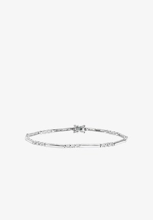 Hopeinen rannekoru, jossa vuorottelevat kapeat ja leveät osiot, pienillä kirkkailla kivillä koristeltu. Sileä pinta, kiinnitetty lukolla.