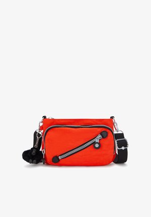 Bright orange crossbody bag with diagonal front zipper pocket, black adjustable strap, and small black plush keychain attached.