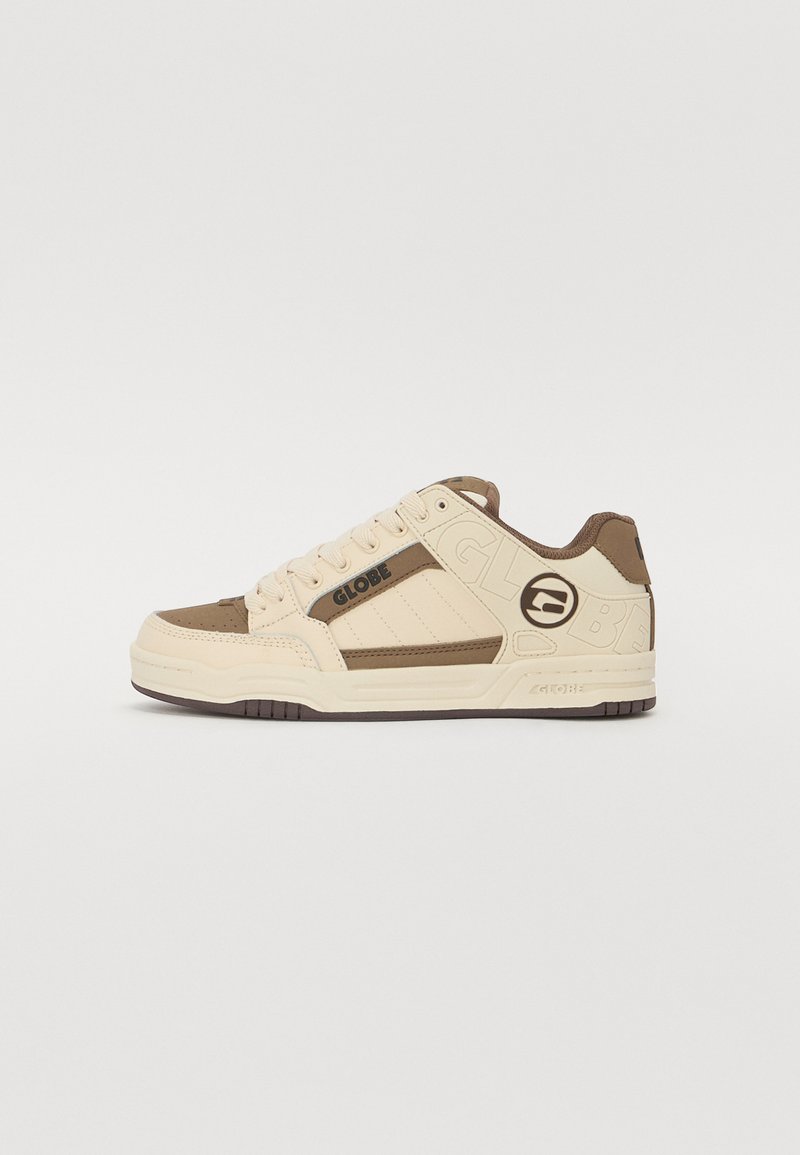 Beige sneakers with brown accents, made of leather and suede, featuring a textured sole, logo detail, and padded collar for comfort.