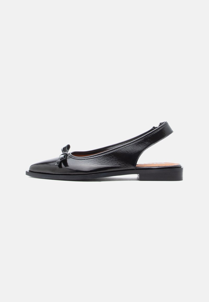 Chaussure slingback en cuir verni noir avec un bout pointu et un petit nœud décoratif à l'avant, dotée d'une semelle plate et d'une surface texturée.