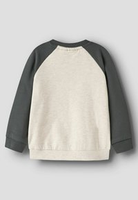 Sweatshirt à manches longues crème et gris foncé avec manches raglan, tissu texturé, poignets côtelés et encolure arrondie.