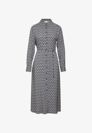 Sukienka z długim rękawem zapinana na guziki, w czarno-białym geometrycznym wzorze, z odcinanym w pasie i kołnierzykiem, wykonana z lekkiego materiału.