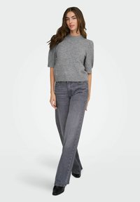 Gray knit sweater with short sleeves, embellished with small decorative pearls, paired with high-waisted dark gray wide-leg jeans and black ankle boots.