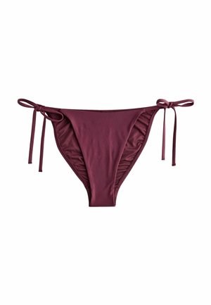 Bikiniunderdel i djup bordeaux, tillverkad av mjuk tyg. Har sidoknytningar och vågiga kanter för justering och stil.