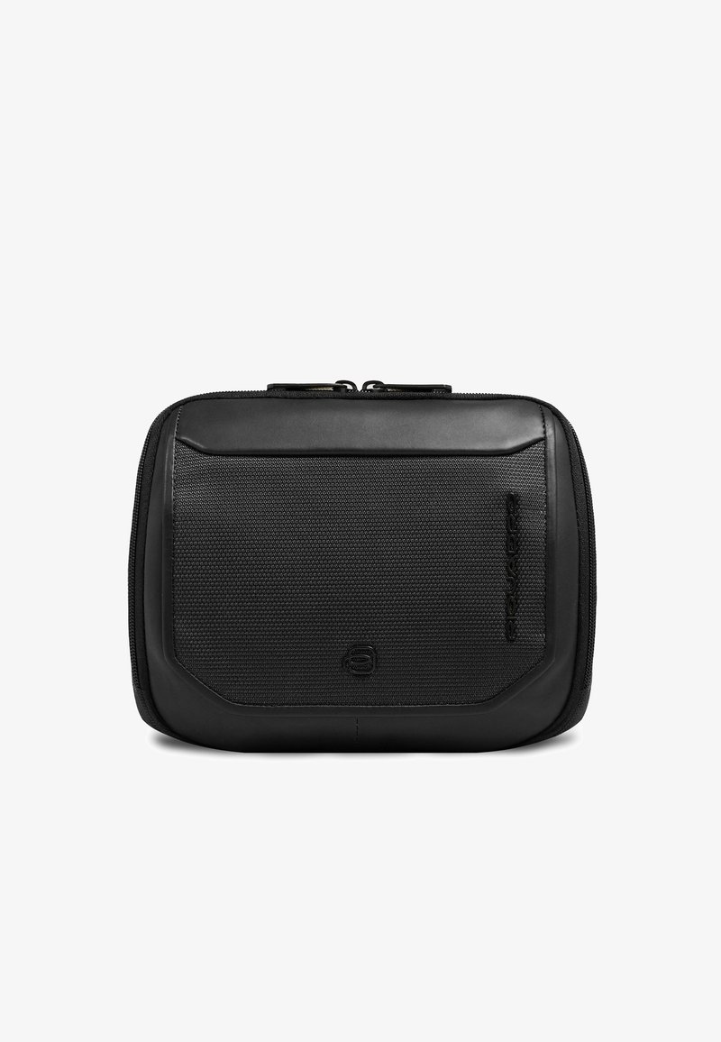 Petite pochette noire zippée avec un panneau avant texturé, des bords lisses et un logo discret embossé et imprimé verticalement sur le côté.