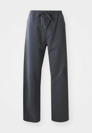 Pantalons noirs à taille élastique avec cordon de serrage, présentant une coupe droite et une texture lisse. Pas de poches visibles ni de motifs.