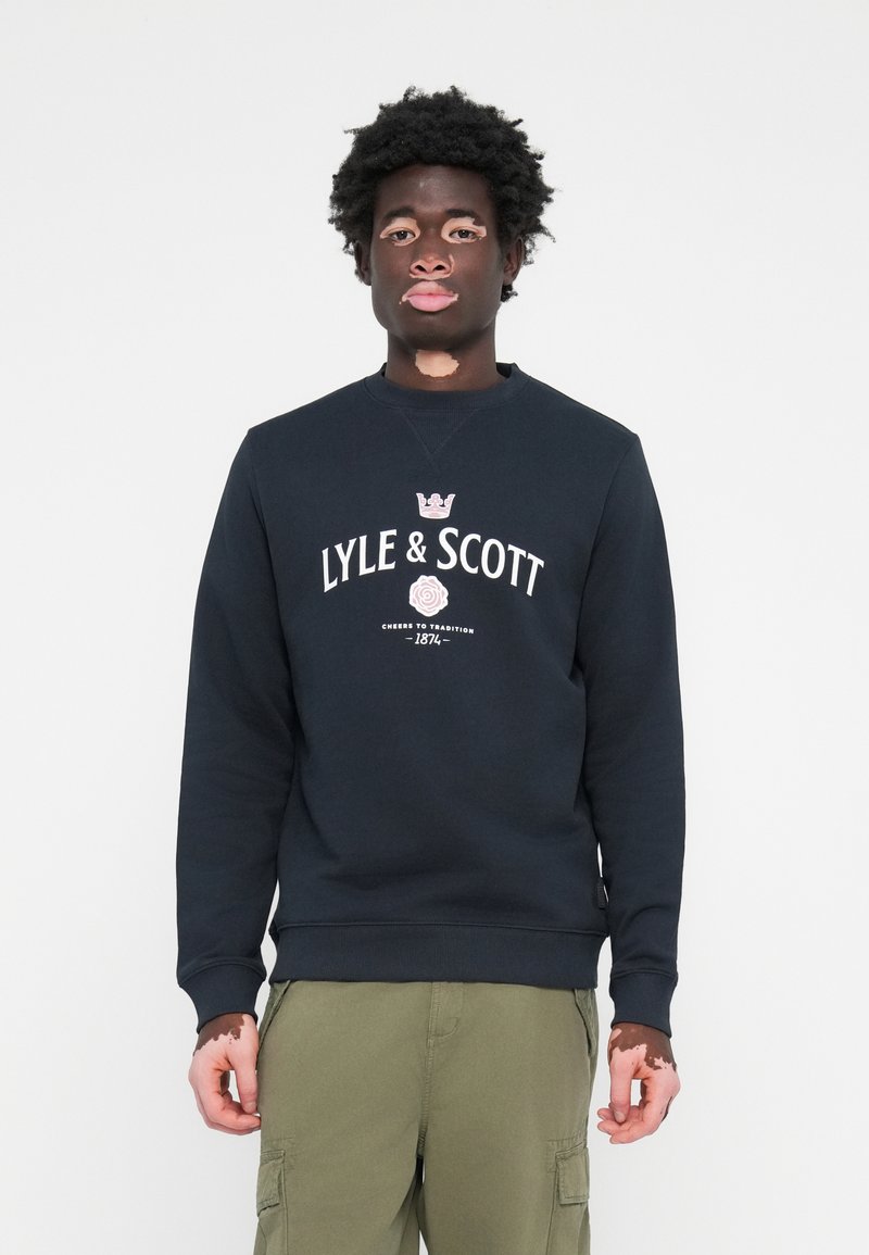 Navy crewneck sweatshirt featuring "LYLE & SCOTT" logo in white with a crown and rose graphic, made of soft cotton blend fabric.