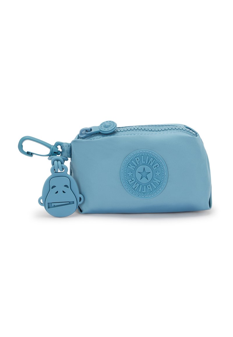 Blue zippered pouch made of smooth material with a round logo and a rubber monkey charm attached. Compact design for easy portability.