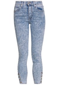 Light blue denim jeans with a slim-fit design, featuring a high waist, five pockets, and small button accents at the ankle.