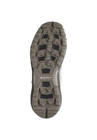 La semelle de chaussure présente un design robuste avec des reliefs triangulaires, des couleurs beige et noire, ainsi qu'une marque Michelin près du centre.