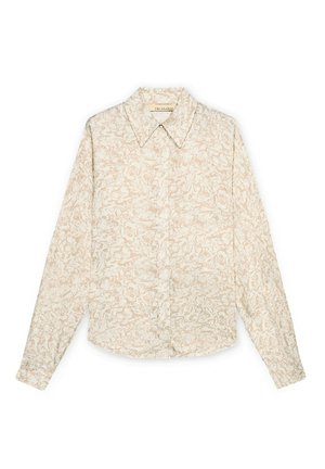 Chemise crème à manches longues avec boutons, imprimé floral rose pâle et col pointu, posée à plat sur un fond blanc.