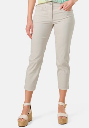 Light beige cropped pants with a smooth texture, five-pocket design, and subtle stitching. Paired with cream espadrille platform sandals.