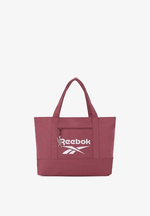 Bordowa torba Reebok typu tote z podwójnymi uchwytami, przednią kieszenią na zamek oraz białym logo na jednolitym tle.