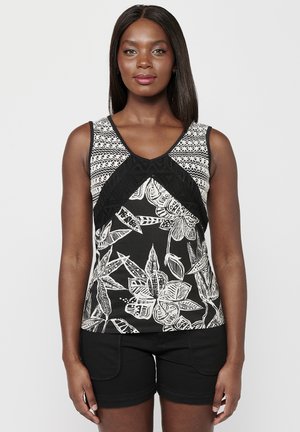 Top sans manches à imprimé floral noir et blanc avec un décolleté en V, doté d'un tissu à motifs aux épaules et d'accents texturés noirs.