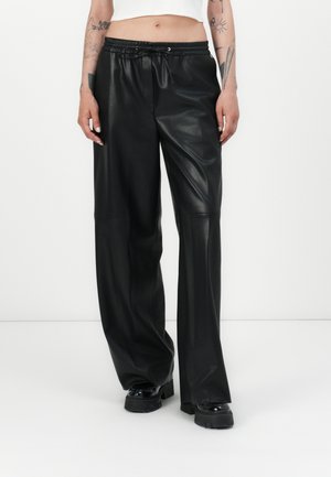 HASABELLE - Leather trousers - black