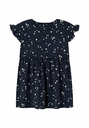 Vestido de algodón azul marino con mangas cortas con volantes, falda acampanada y un estampado floral blanco en toda la prenda. Presenta un escote redondo.