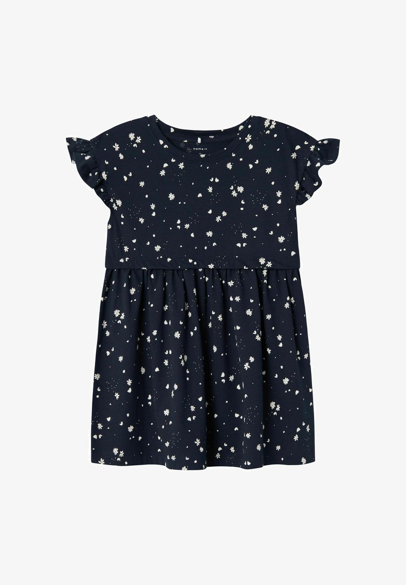 Vestido de algodón azul marino con mangas cortas con volantes, falda acampanada y un estampado floral blanco en toda la prenda. Presenta un escote redondo.