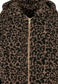 Chaqueta de piel sintética con un estampado de leopardo en negro y marrón, con una cremallera dorada y un cuello alto. Textura suave con un aspecto acogedor.