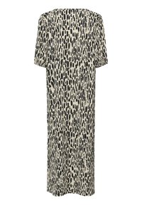 Short-sleeved dress in a light cream color with a bold black abstract pattern, featuring a loose fit and knee-length cut.
