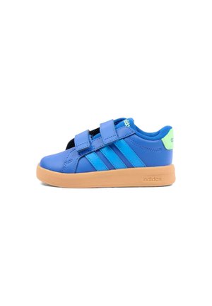 Zapatilla infantil azul de Adidas con dos tiras de Velcro, suela marrón claro, lengüeta del talón verde brillante y tres rayas azules en el lateral.