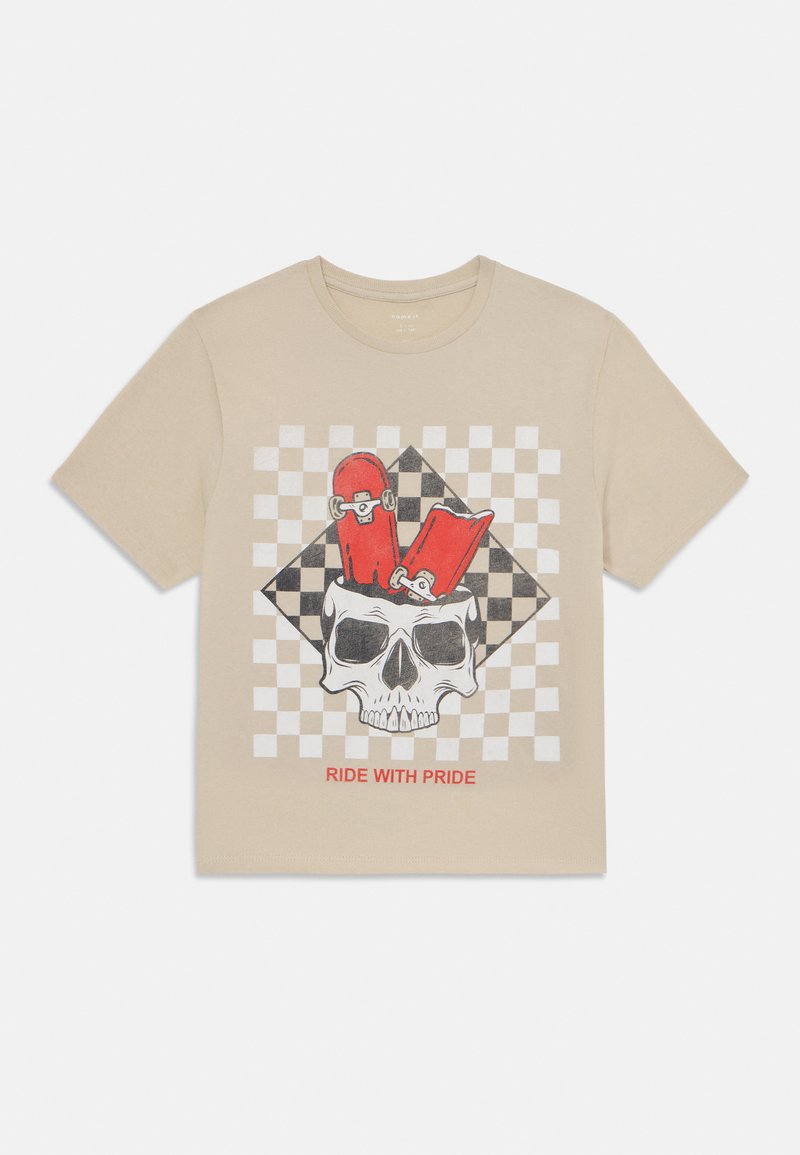 Beige cotton t-shirt featuring a black and white checkered pattern behind a central skull graphic with red accents and the text "RIDE WITH PRIDE."