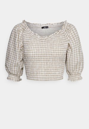 Blusa curta com decote quadrado, mangas bufantes e textura franzida. Apresenta um padrão xadrez em bege claro e branco.