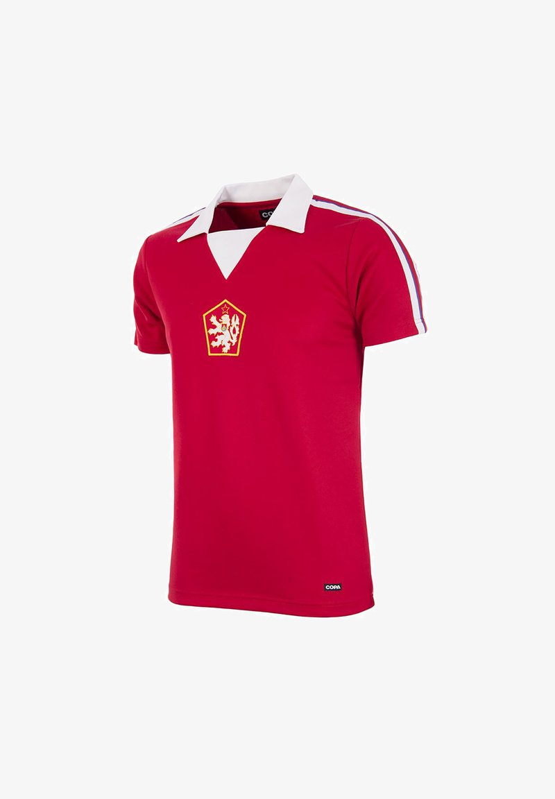 Red short-sleeve sports shirt with white collar, lion crest on chest, and red, white, blue stripes on shoulders, labeled Copa at hem.