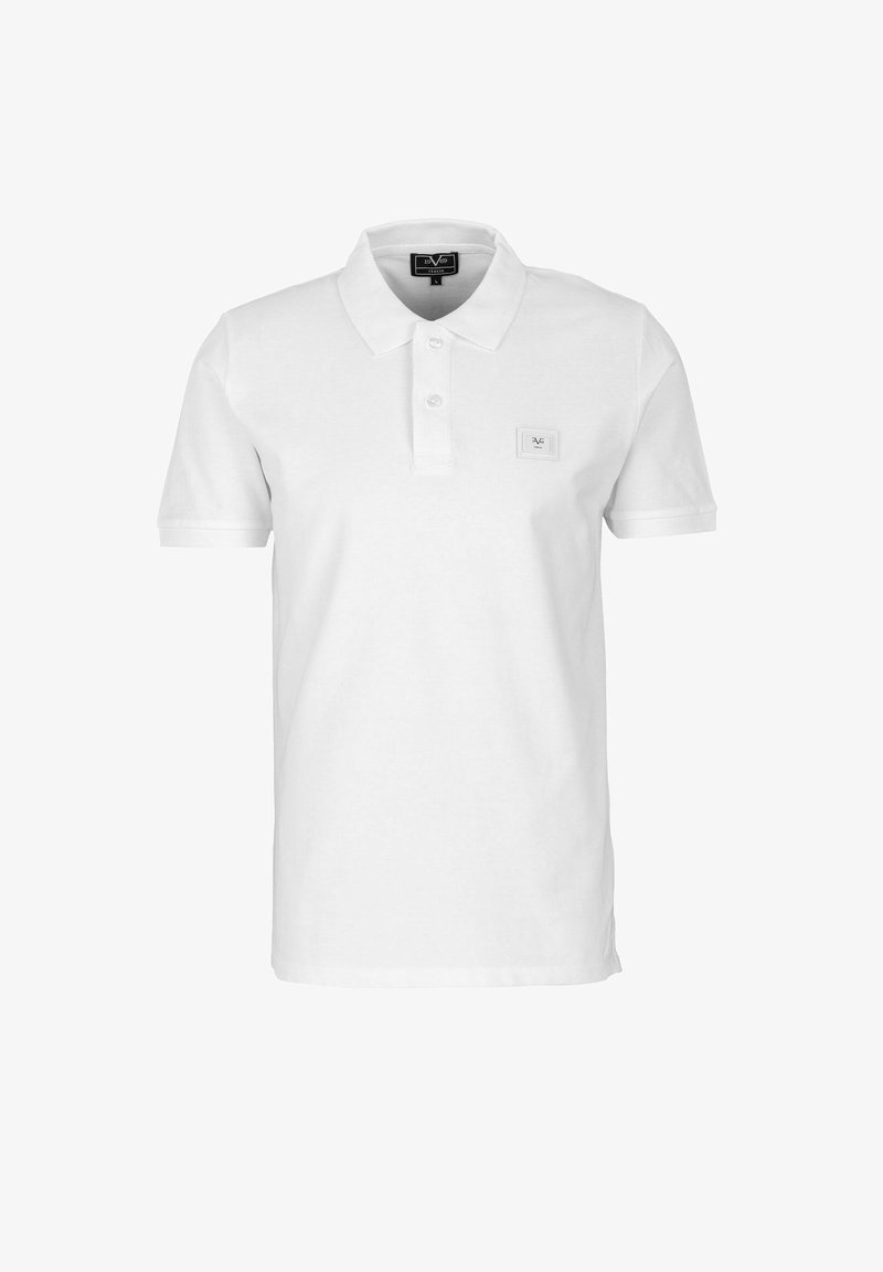 Polo shirt bianco in cotone, con colletto classico, pattina con tre bottoni, maniche corte e un piccolo etichetta con il marchio sul petto.