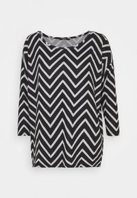 Paita pitkähihaisella mustavalkoisella chevron-kuviolla, pyöreällä kaula-aukolla ja pehmeällä tekstuurilla. Rentoa mitoitusta, kevyttä kangasta.