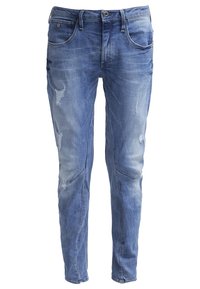 Ljusblå denimjeans med blekta områden och slitna detaljer. Har klassisk femficksdesign och smal benform.