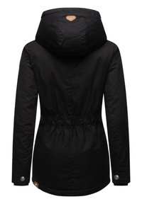 Black hooded jacket with a drawstring waist, buttoned cuffs, and a textured patch logo on the back. Smooth fabric and tailored fit.