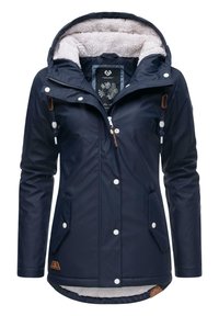 Navy waterproof jacket with faux fur lining, drawstring hood, snap buttons, and two side pockets. Brown leather brand tag at hem.