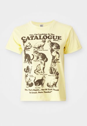 Yellow cotton t-shirt featuring black cat illustrations and text: “Yes, I’m Looking At The CATALOGUE Now...”. Sized crew neck, short sleeves.
