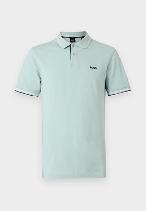 Hele roheline puuvillane polosärk, millel on klassikaline krae, kolmenupuline rihm ja must logo. Kaunistatud valgete triibuliste varrukatõmmetega.