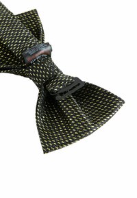 Black bow tie featuring a textured fabric with yellow accents, secured with a black clip. Tag visible with care instructions.