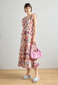 Rochie midi florală cu mâneci volan în roz, având o fustă în straturi. Asortată cu o pereche de pantofi cu degete deschise în albastru deschis și o geantă roz.